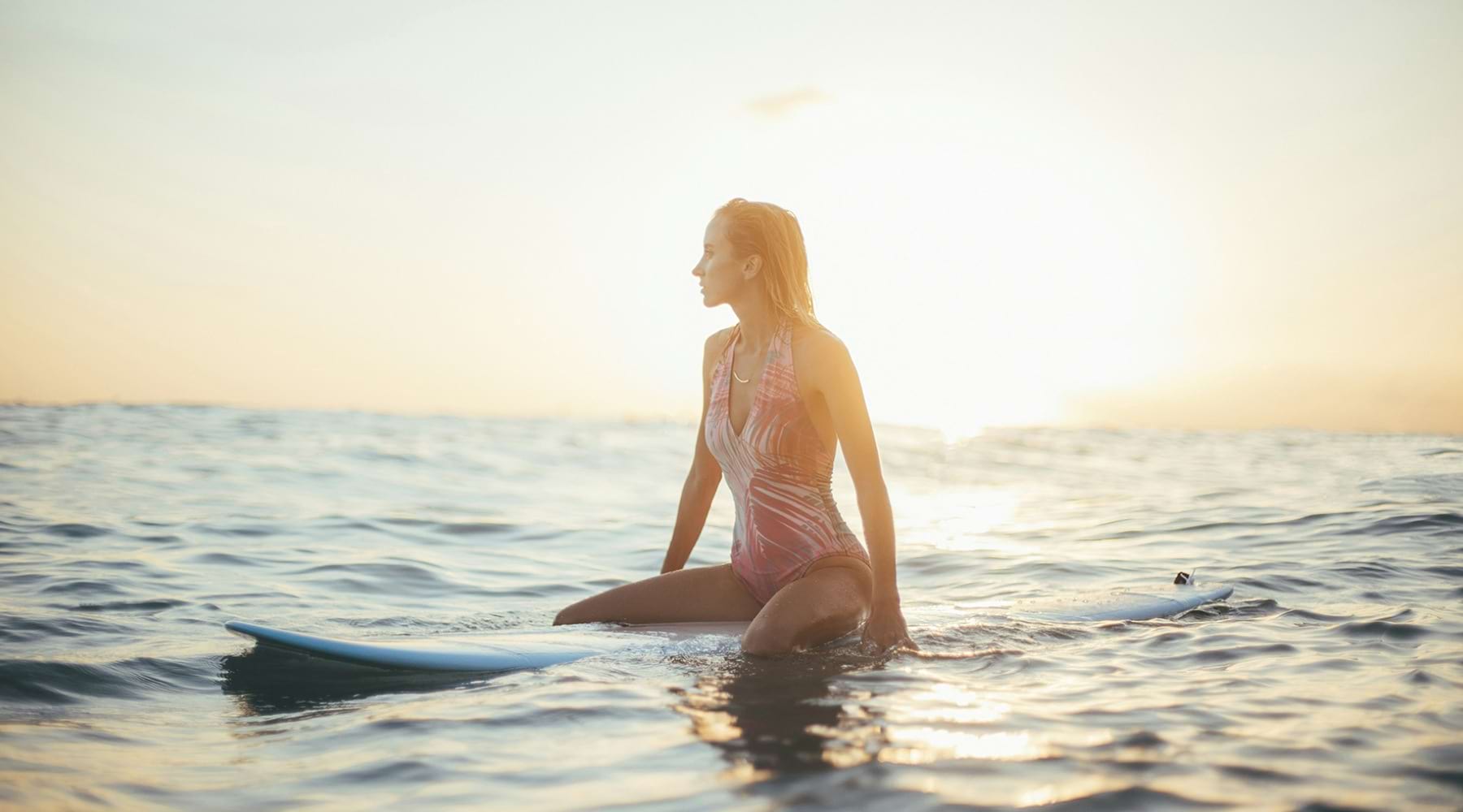 At the center of it all a woman on a surfboard
